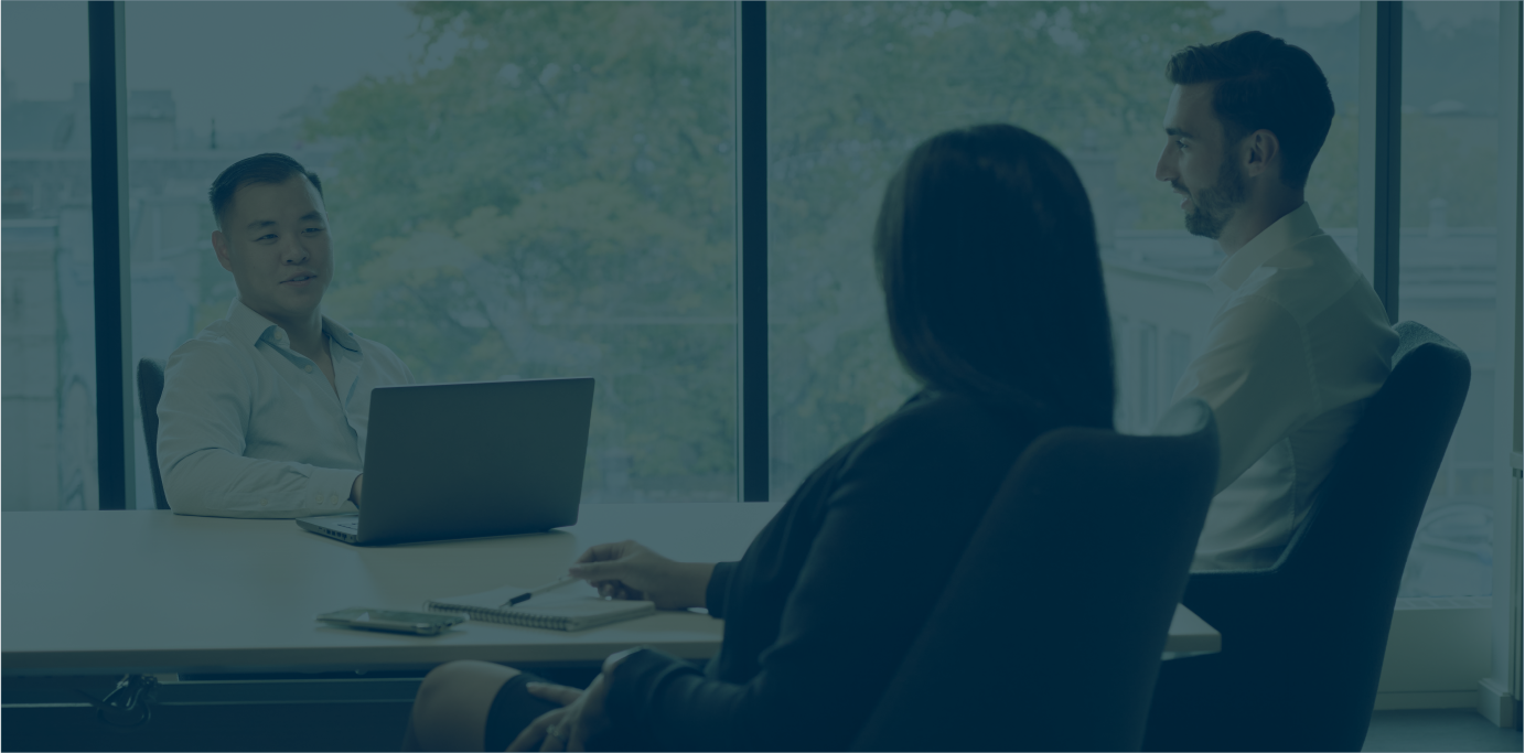 Three people in a meeting room