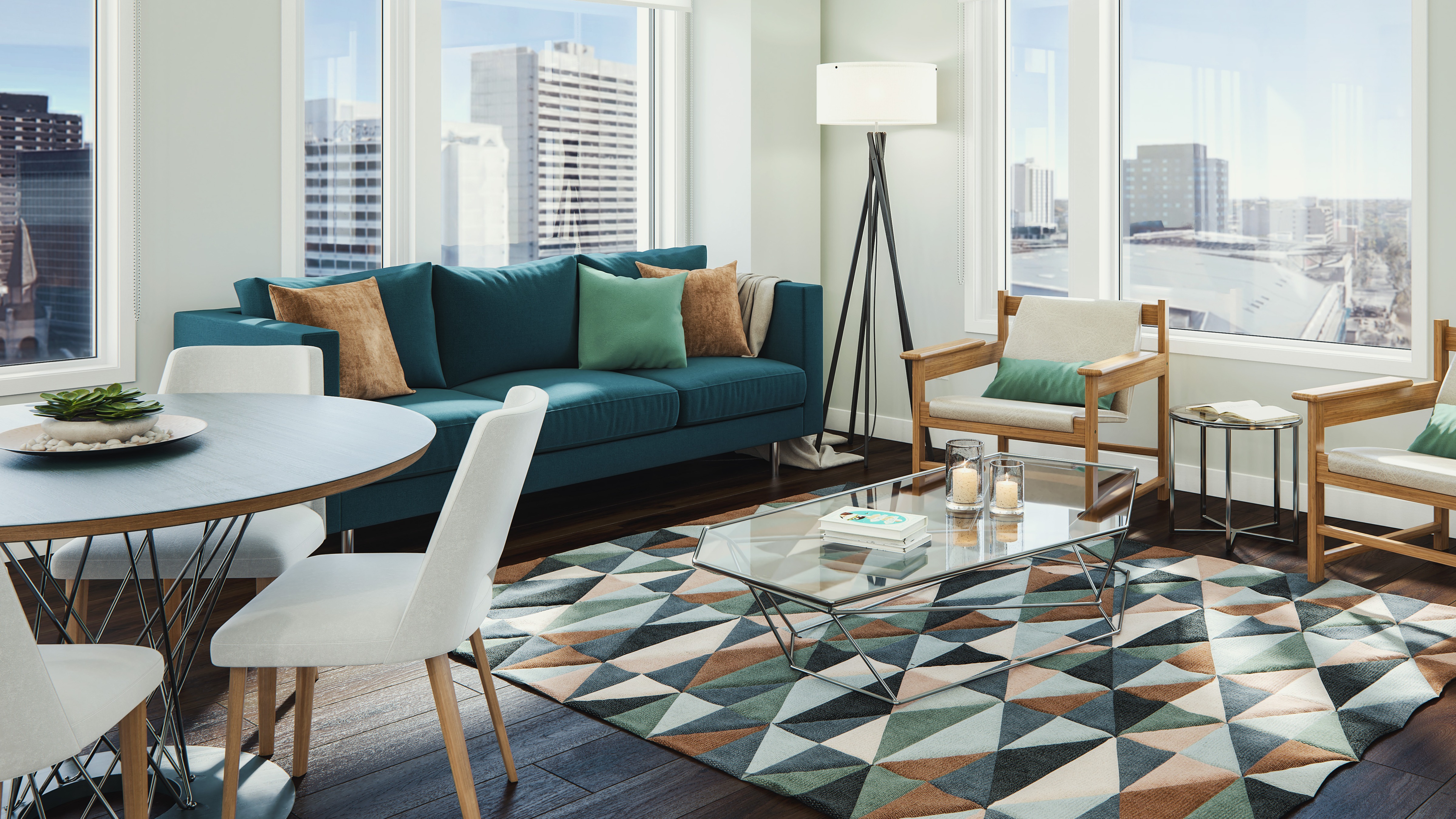 Interior of apartment suite with windows, couch, coffee table and kitchen table.