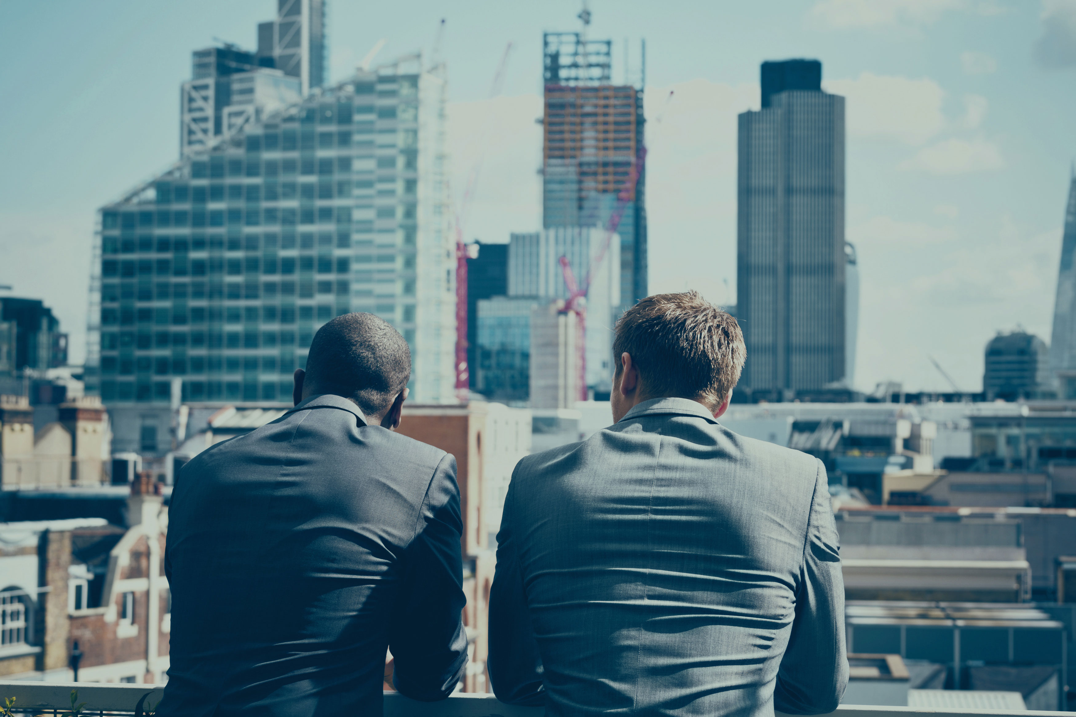 Bottom Up Focus Two men overlooking a city skyline